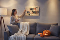 TK Wood Designs Happy Halloween wooden sign with dripping black and orange letters and bat silhouettes.
