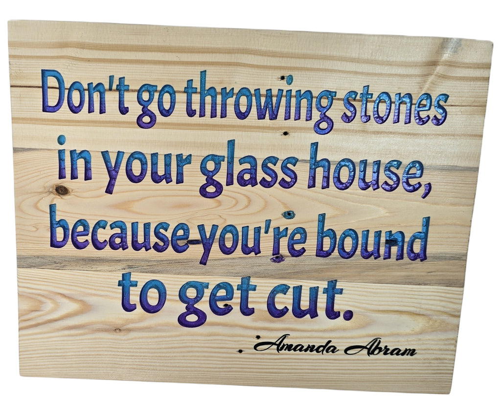 TK Wood Designs natural wood sign with blue and purple gradient text quote "Don't go throwing stones in your glass house, because you're bound to get cut."