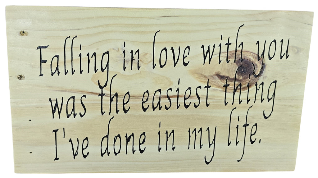 TK Wood Designs natural wood sign with black script saying "Falling in love with you was the easiest thing I've done in my life."