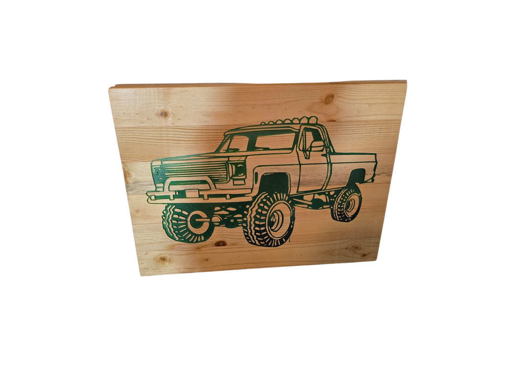 TK Wood Designs natural wood wall art featuring a lifted monster truck silhouette in dark green. Rustic automotive decor.