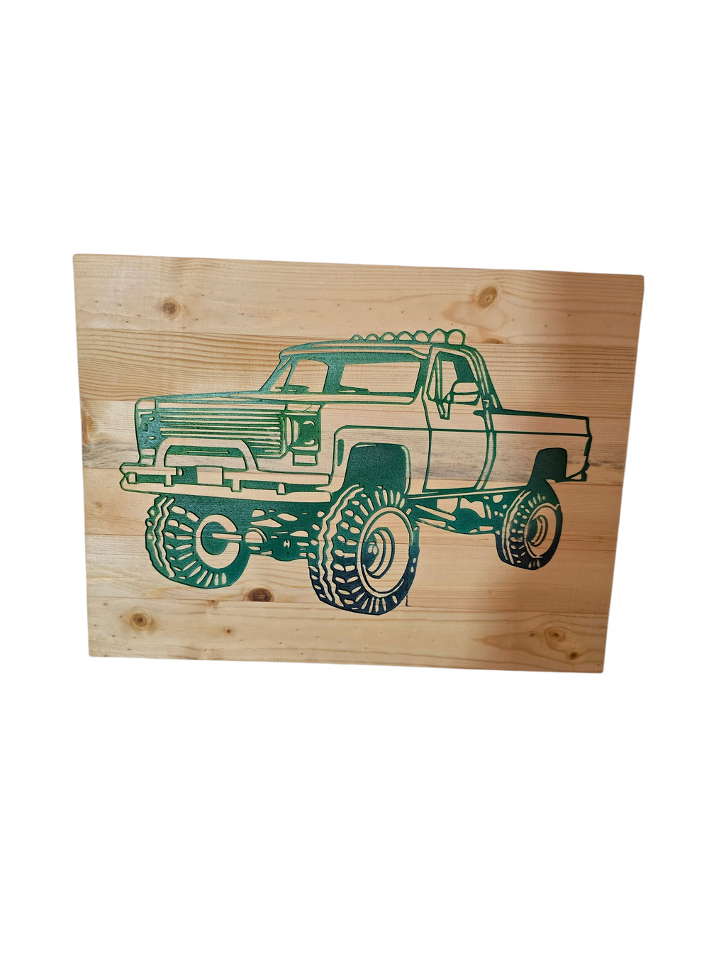 TK Wood Designs natural wood wall art featuring a green monster truck silhouette with large tires. Rustic automotive decor.