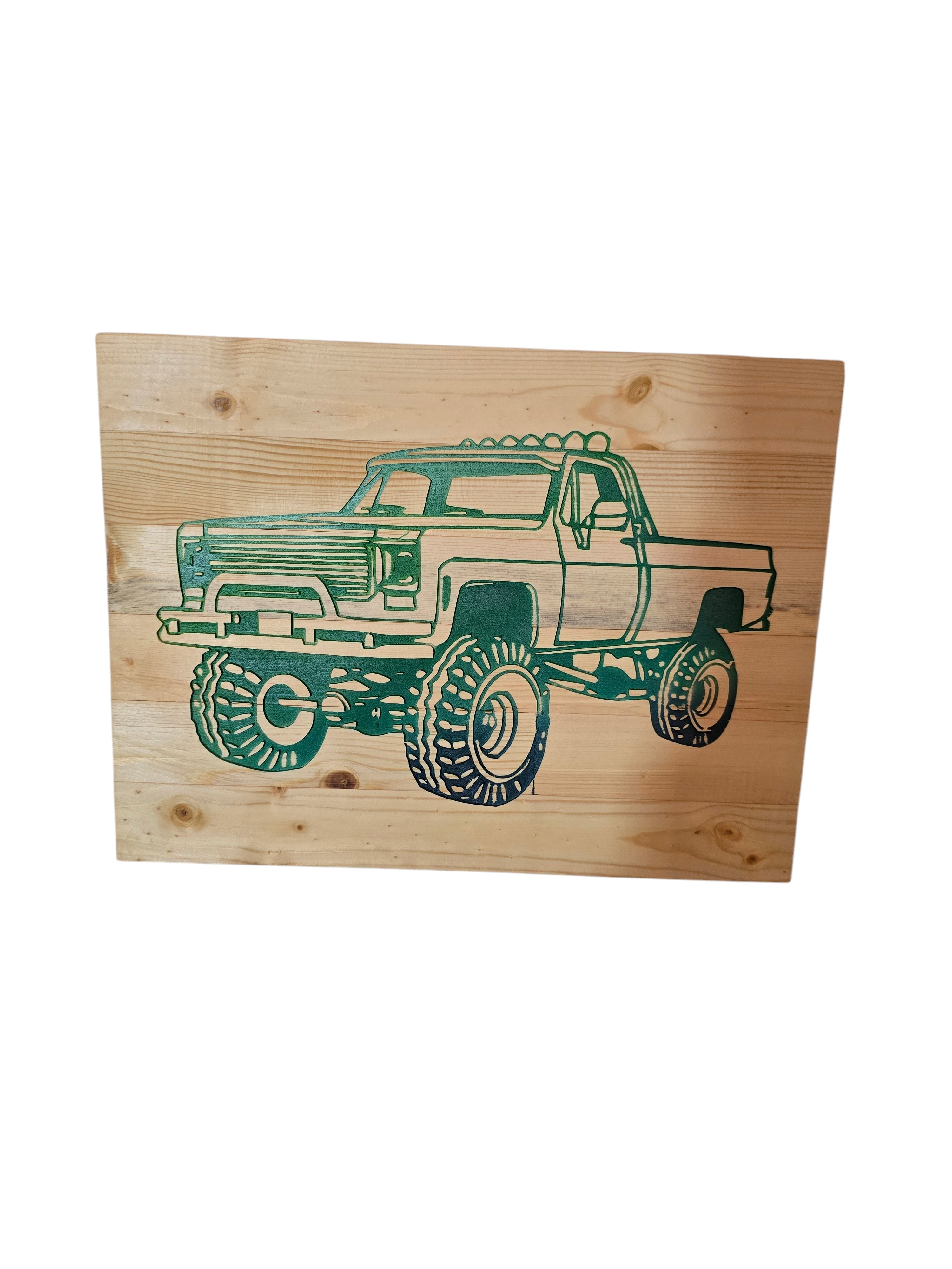 TK Wood Designs natural wood wall art featuring a green monster truck silhouette with large tires. Rustic automotive decor.