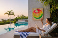 TK Wood Designs neon beach scene wood sign with palm trees, sun, and water in vibrant pink, orange, yellow, and green.