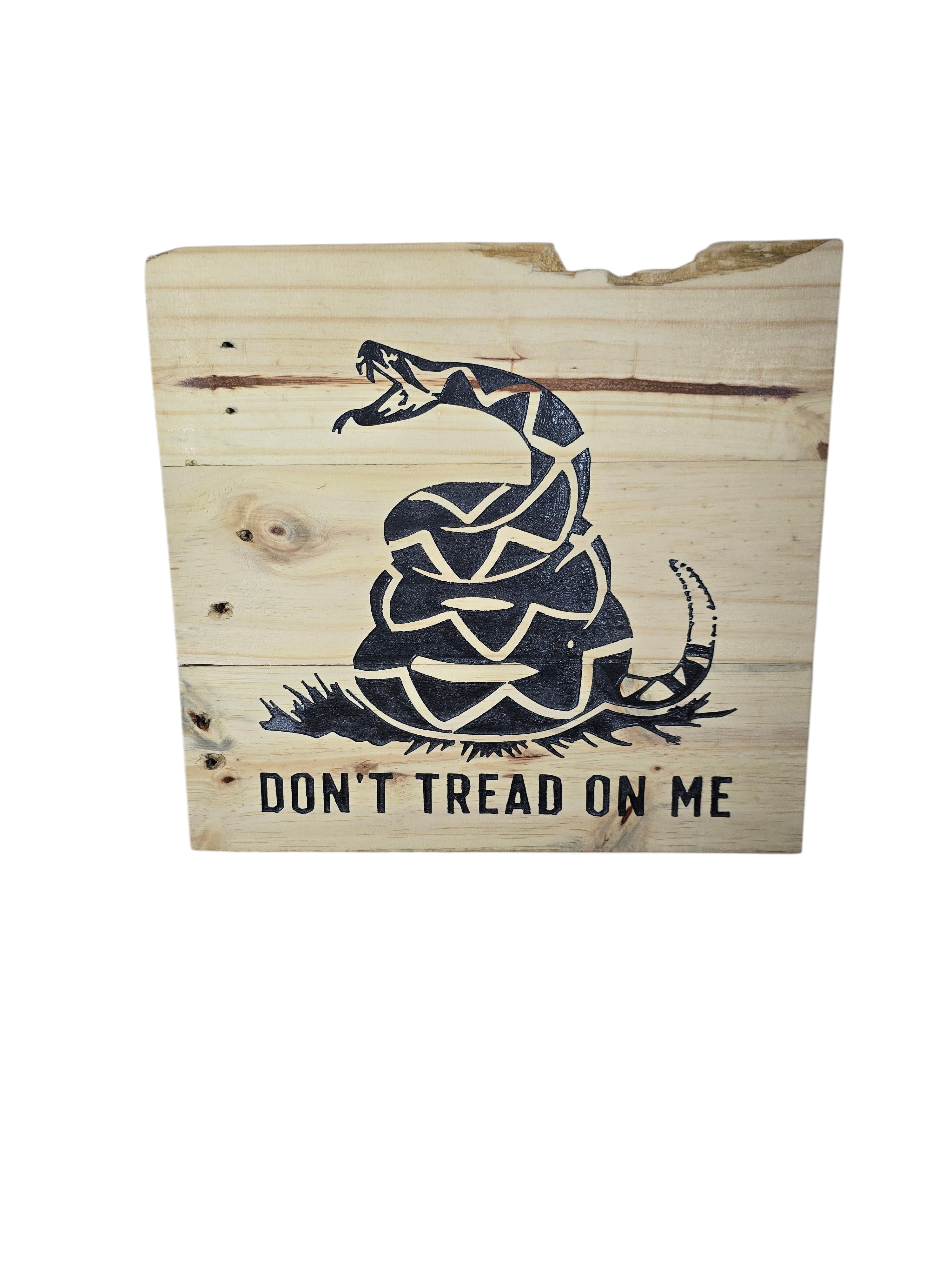 TK Wood Designs natural wood wall art featuring a coiled rattlesnake graphic and "Don't Tread On Me" text. Rustic design.