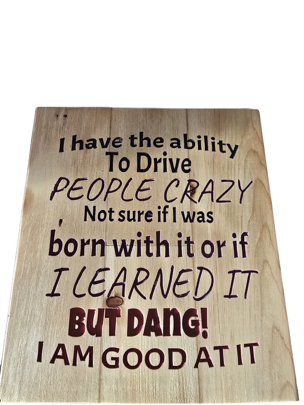 TK Wood Designs reclaimed wood sign with carved text saying "I have the ability to drive people crazy, Not sure if I was born with it or if I LEARNED IT BUT DANG! I AM GOOD AT IT."
