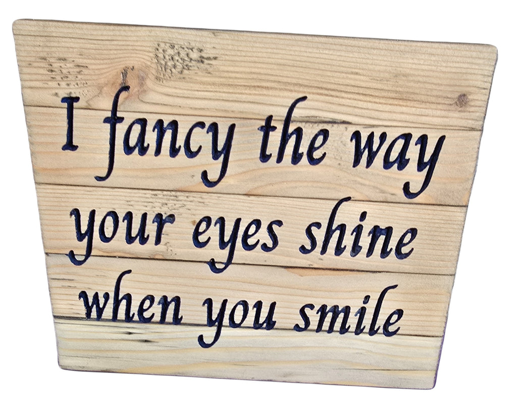 TK Wood Designs reclaimed wood sign with carved blue text reading "I fancy the way your eyes shine when you smile".