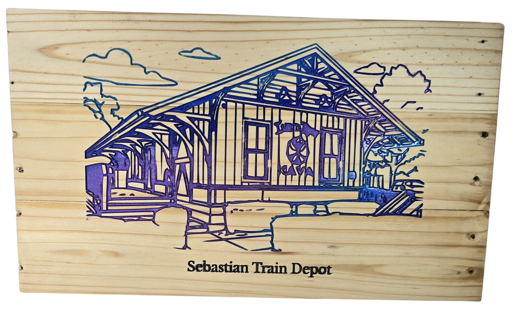 TK Wood Designs Sebastian Train Depot wooden art, featuring a blue and purple engraved depiction of the historic station with clouds.