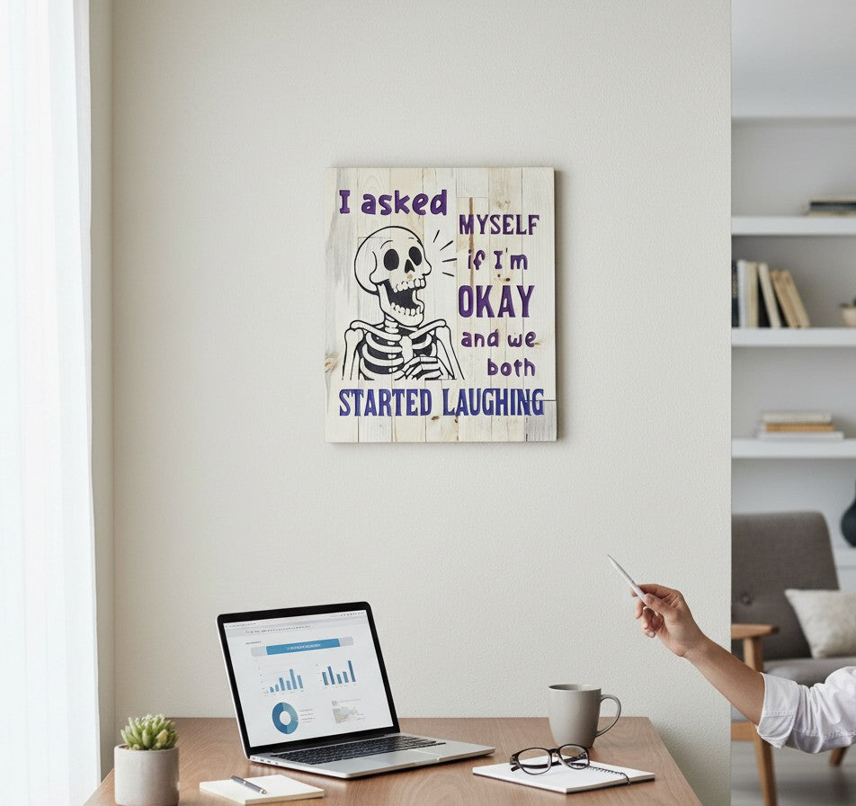 TK Wood Designs reclaimed wood sign with a skeleton graphic and purple text reading "I asked MYSELF if I'm OKAY and we both STARTED LAUGHING."