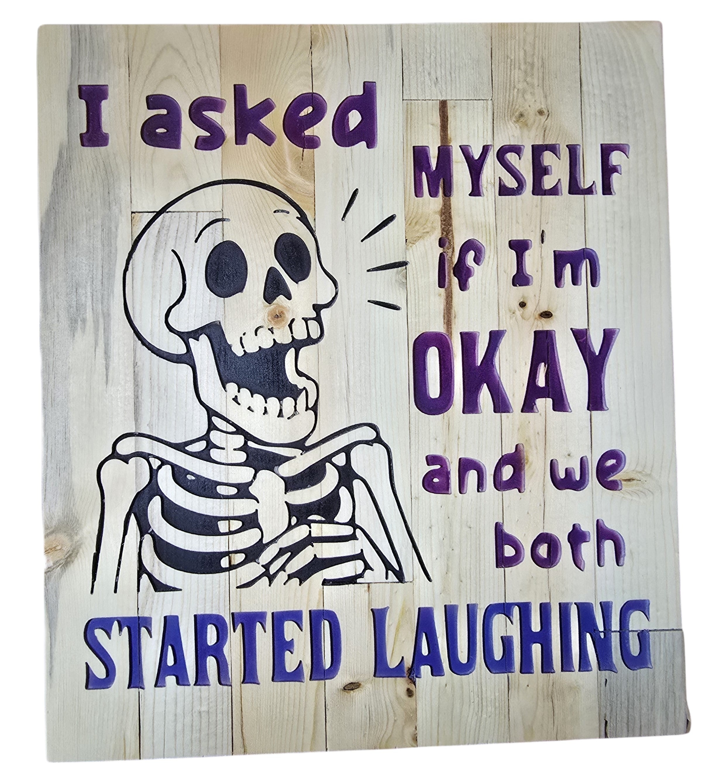 TK Wood Designs reclaimed wood sign with a skeleton graphic and purple text that reads "I asked MYSELF if I'm OKAY and we both STARTED LAUGHING."
