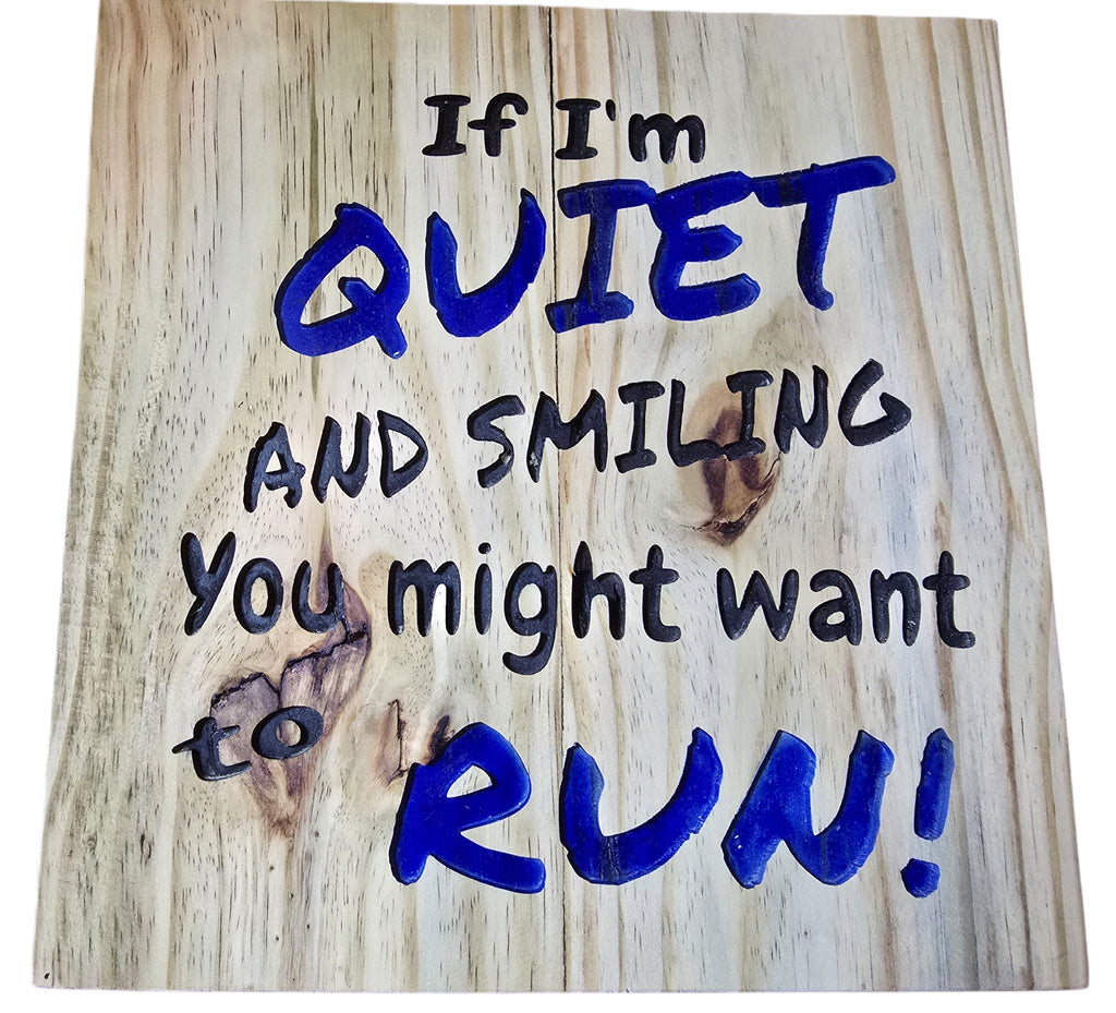 TK Wood Designs natural wood wall art with bold blue lettering saying "If I'm Quiet and Smiling, You Might Want to Run!"