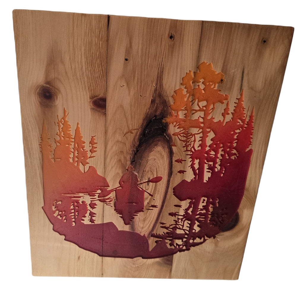 TK Wood Designs natural wood wall art with a woodland scene, featuring a kayaker and trees in warm orange and red tones.